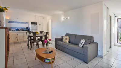 a living room with a couch and a table at locations calenzana in Calenzana