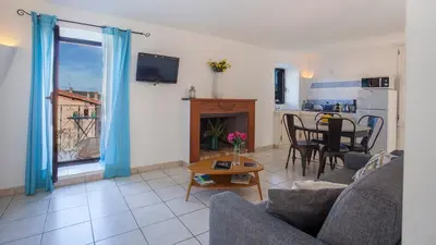 a living room with a couch and a table at locations calenzana in Calenzana