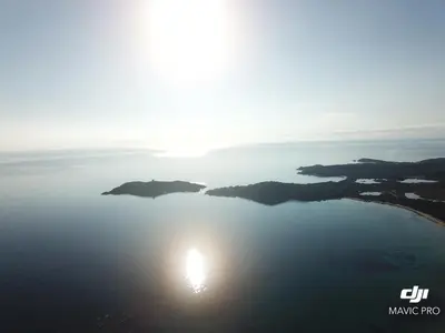 an island in the middle of a body of water at Le Pinarello in Sainte-Lucie de Porto-Vecchio