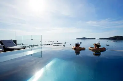 two people in the water in a swimming pool at Le Pinarello in Sainte-Lucie de Porto-Vecchio