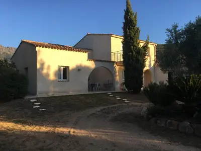 a white house with a tree in front of it at Studio Pinzali Avec Mezzanine in Calenzana