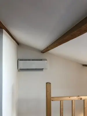 a ceiling fan in a room with white walls at Studio Pinzali Avec Mezzanine in Calenzana