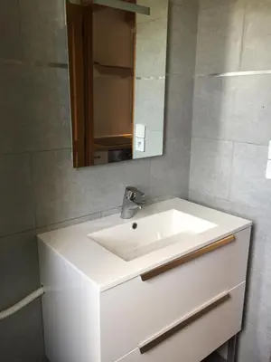 a bathroom with a white sink and a mirror at Studio Pinzali Avec Mezzanine in Calenzana