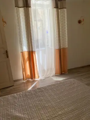 a kitchen with a table and chairs in a room at T2 Sartène centre ville in Portigliolo