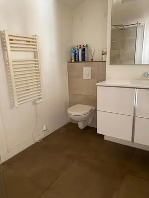 a bedroom with a bed and a white cabinet at T2 Sartène centre ville in Portigliolo