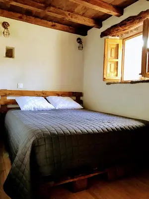 a bedroom with a bed in a room with a window at U Fragnu in Omessa