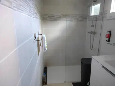 a white bathroom with a shower and a sink at Maison Lisa Maria in Ponte-Leccia