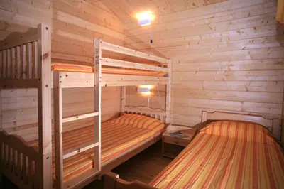 a bedroom with two bunk beds in a cabin at Camping Les Oliviers in Porto Ota