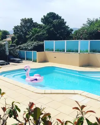 a swimming pool with a pink swan in it at Villas CALA CORSA - 3 chambres piscine partagée chauffée - CALA ROSSA Porto-Vecchio - Villas entièrement Climatisées - Internet gratuit in Porto-Vecchio