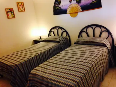 two beds sitting next to each other in a room at Résidence Playa Del'Oro in Favone