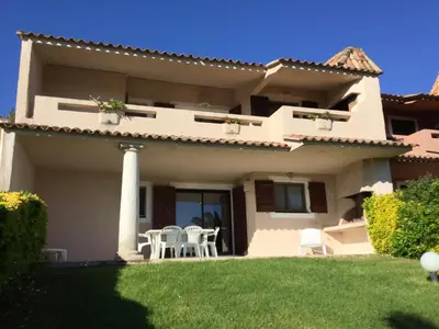a large house with a lawn in front of it at Résidence Playa Del'Oro in Favone