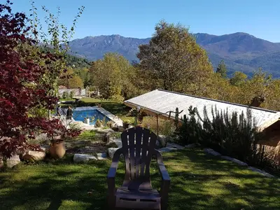 a chair in a yard with a view of a garden at Bergerie avec piscine in Tasso