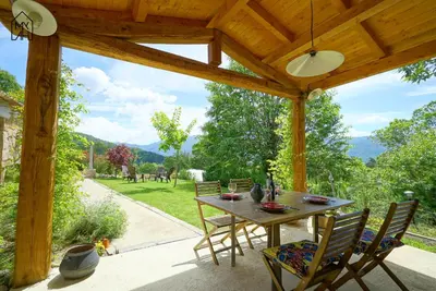 a table and chairs on a patio with a view at Bergerie avec piscine in Tasso