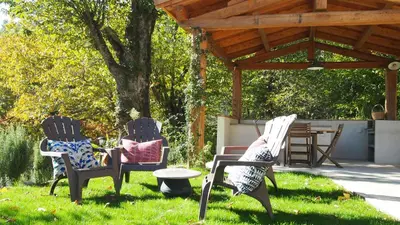 two chairs and a table in a yard at Bergerie avec piscine in Tasso