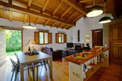 a kitchen and living room with a table and chairs at Bergerie avec piscine in Tasso