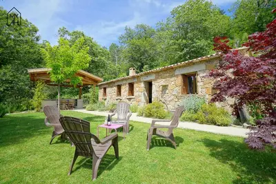 a group of chairs and tables in a yard at Bergerie avec piscine in Tasso
