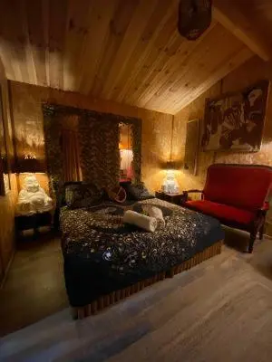 a bedroom with a bed and a red chair at Chalet Valle di Corti in Pianottoli-Caldarello
