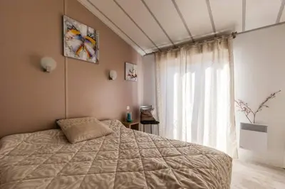 a bedroom with a bed and a window at Chalet Valle di Corti in Pianottoli-Caldarello