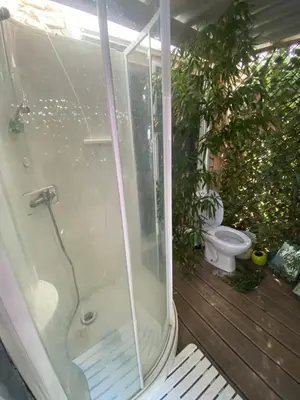 a bathroom with a shower and a toilet on a deck at Chalet Valle di Corti in Pianottoli-Caldarello