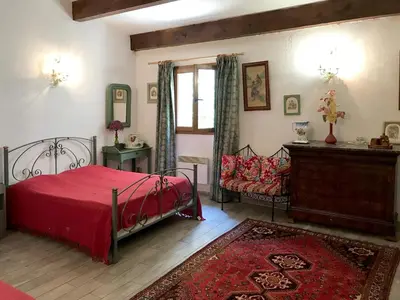 a bedroom with a red bed and a window at U Fragnu di perruccio in Levie
