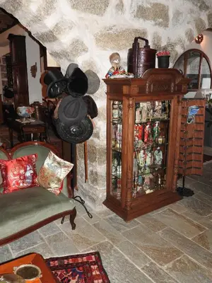 a room with a wooden cabinet filled with items at U Fragnu di perruccio in Levie