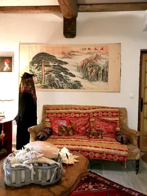 a living room with a couch and a painting on the wall at U Fragnu di perruccio in Levie