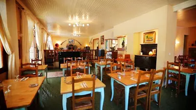 a building with tables and chairs in front of it at Sole E Monti in Quenza