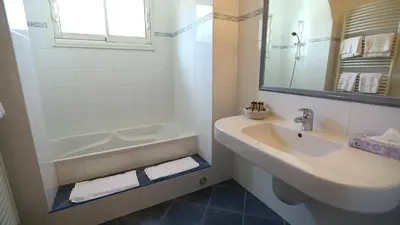 a bathroom with a sink and a tub and a mirror at Sole E Monti in Quenza