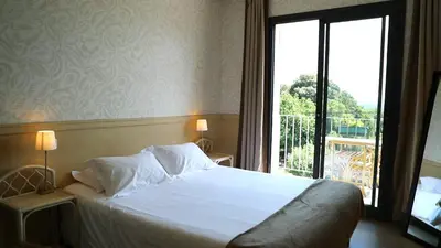 a bed in a hotel room with a large window at Sole E Monti in Quenza