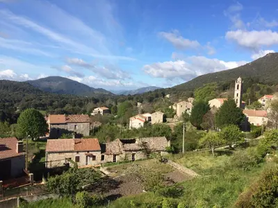 a village in the hills with mountains in the background at Sole E Monti in Quenza