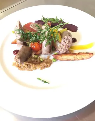 a white plate of food with meat and vegetables at Sole E Monti in Quenza
