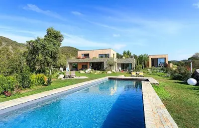 a house with a swimming pool in front of a house at Les lofts de palombaggia in Porto-Vecchio