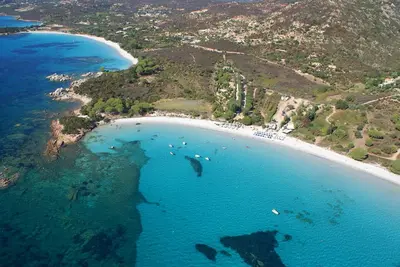 an aerial view of a beach with boats in the water at Les lofts de palombaggia in Porto-Vecchio