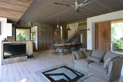 a living room with a couch and a fireplace at Les lofts de palombaggia in Porto-Vecchio