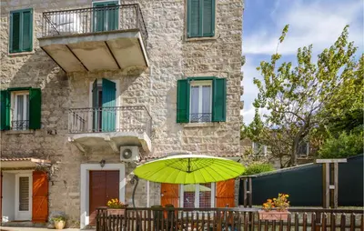 a yellow umbrella in front of a building at 1 Bedroom Cozy Apartment In Zonza in Zonza