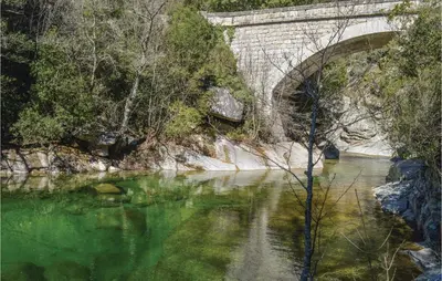 a bridge over a river with green water at 1 Bedroom Cozy Apartment In Zonza in Zonza