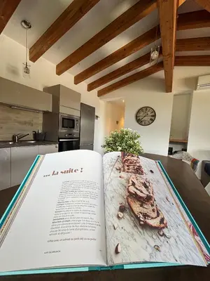 a book sitting on a table with a kitchen at Villa Giulia in Porto-Vecchio