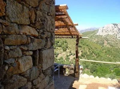 a stone building with a view of a mountain at Les Bergeries 