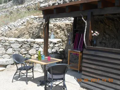 a table and chairs sitting outside of a building at Les Bergeries 