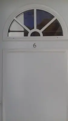 a white door with a window above it at Les Chênes Verts in Corte