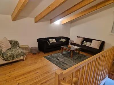 a living room with a couch and a table at Les Chênes Verts in Corte