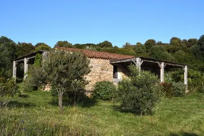 an old stone building in the middle of a field at Casa Lysandra in Serra-di-Ferro