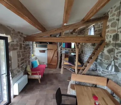 a wooden table and chair with a television on a wall at Casa Lysandra in Serra-di-Ferro