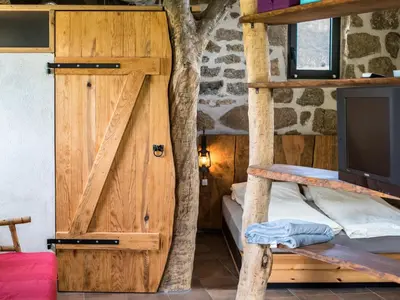a room with a wooden door and a tv at Casa Lysandra in Serra-di-Ferro