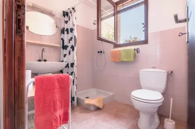 a bathroom with a toilet and a sink at La Tour in Linguizzetta