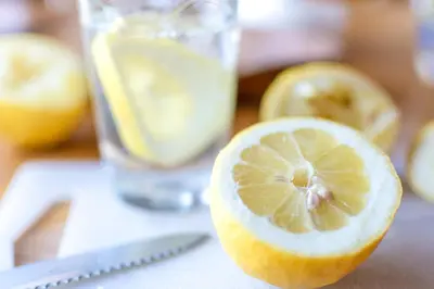 a lemon cut in half next to a glass of water at La Tour in Linguizzetta