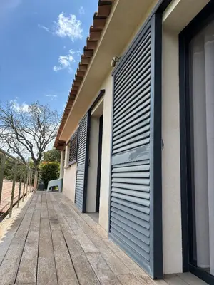 a building with a garage door on the side of it at Villa Santa in Porto-Vecchio