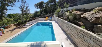a swimming pool in front of a building at Villa Santa in Porto-Vecchio