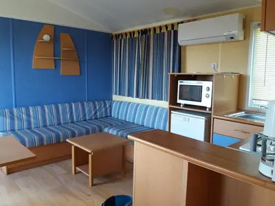 a living room with a couch and a kitchen at La Canardiere in Casta