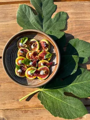 a bowl of food on a table with a large leaf at L'Aghjalle in Santa-Reparata-di-Balagna